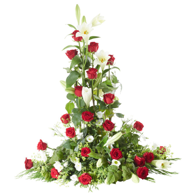 Klassisk och traditionell fristående sorgdekoration i färgerna rött och vitt med rosor,liljor och vita prärieklockor. Buketten är en begravningsblomma och är i mitten av en vit bakgrund.